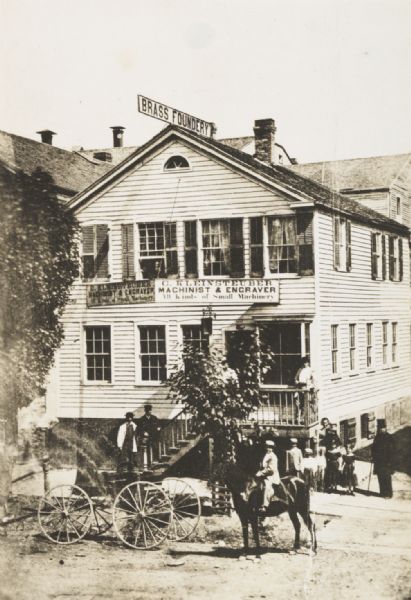 Elevated view of Kleinstueber's Machine Shop, where Christopher Latham Sholes perfected his typewriter. The sign on the top of the building reads: "Brass Foundery."