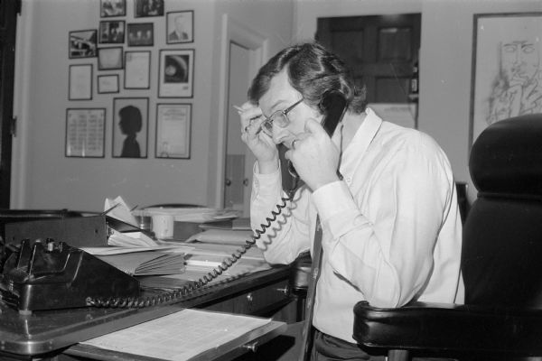 Congressman David R. Obey speaking on the phone in his office. Taken in 1976 this image was used in his 1980 campaign brochure with the caption: "trying to work out a Wisconsin problem with the bureaucracy."