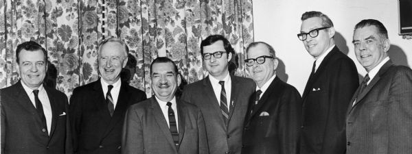 Seven of Wisconsin's ten congressional representatives posed with David R. Obey shortly after his victory in a special election to replace Melvin Laird. Left to right they are: Glenn Davis, Vernon Thomson, Clement Zablocki, Obey, Henry Schadeberg, Robert Kastenmeier, and John Byrnes. Missing are Alvin O'Konski, Henry Reuss, and William Steiger.