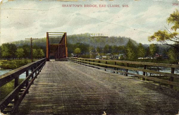 Shawtown Bridge A colorized photographic view of the Shawtown truss bridge. Houses are in the distance, and beyond is a bluff. Caption reads: "Shawtown Bridge, Eau Claire, Wis."