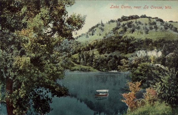 Lake Como Hand-colored elevated view from hill of Lake Como. People are in a boat in the lake. Caption reads: "Lake Como, near La Crosse, Wis."