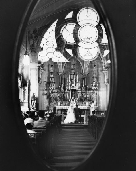 Trauba-Rollinger wedding, as seen through the glass doors at Saint Mary's Catholic Church.