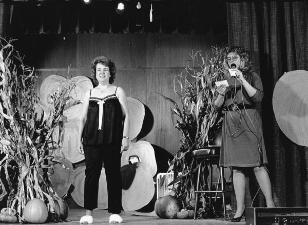 On Wednesday, Oct. 17, 1990, the Theresa Lioness Club sponsored their 3rd annual fashion show. Amidst a festive setting on stage and G & Z's Hall in Theresa. Jan Rueter served as a model. Stage set with pumpkins and cornstalks.