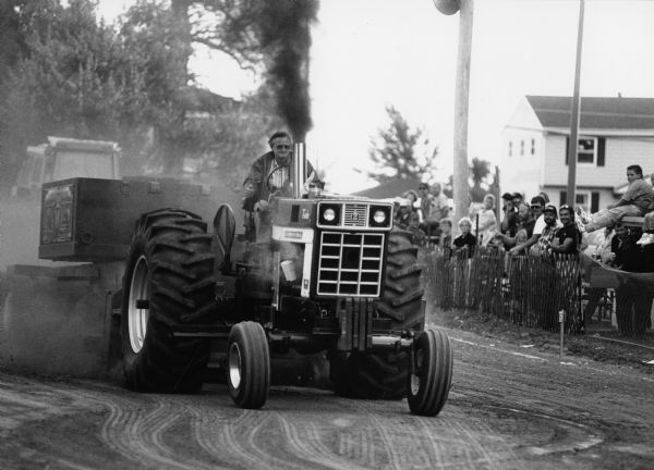 Amid clouds of dust, 112 entrants vied for honors at the Theresa Lions Club Tractor Pull. Stan Waas is shown on the track.