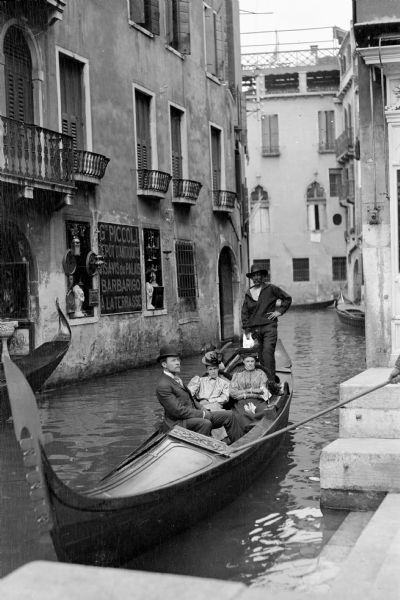 Mary E. Smith, seated on the right, riding a gondola ride with two friends in Venice, Italy.