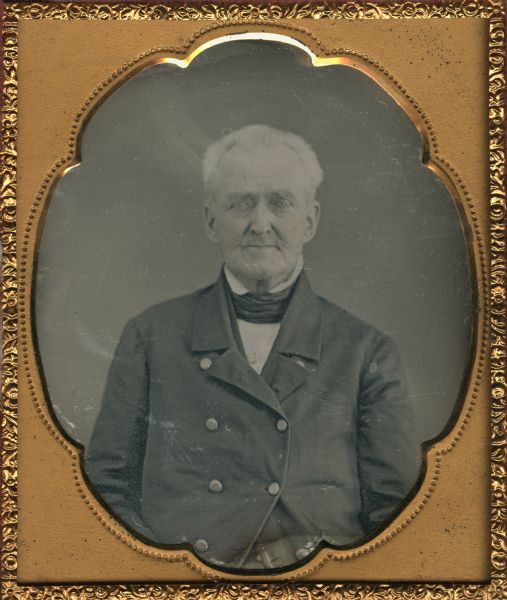 Sixth plate daguerreotype of a waist-up seated portrait of Col. John Johnston. Johnston is pictured here as an elderly man; however, he is remembered in Wisconsin as the founder of a trading post on Chequamegon Bay in 1792. Hand-coloring on the cheeks.