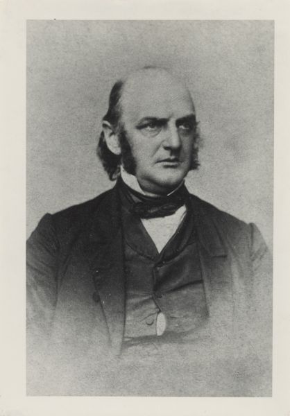 Waist-up portrait of Governor Alexander Randall. He has sideburns, and wears a suit and tie. He is looking to the right.