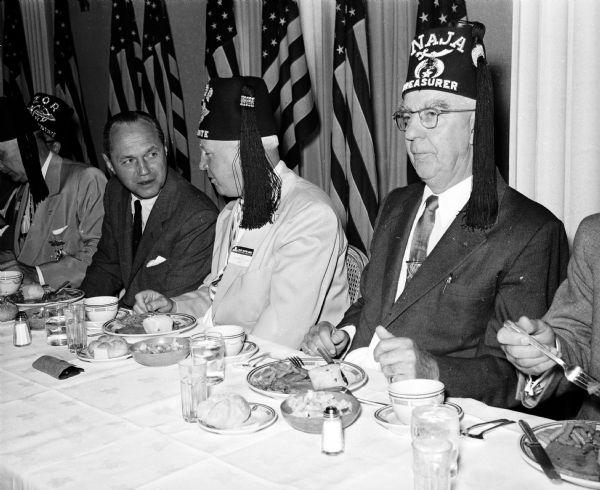 Midwest Shrine Convention Ralph Olson (right), potentate of Zor Shrine of Madison and Wisconsin's adjutant general, visits with Wisconsin governor Walter Kohler during a noon luncheon at the Midwest Shrive Convention in Madison.