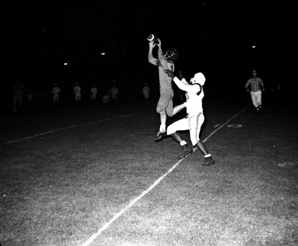 Madison Central-Beloit Football Game Madison Central's Dick Pedracine intercepts a pass intended for Beloit's Fred Price (right) in the Big Eight opener at Breese Stevens Field.
