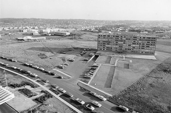 University Hill Farms Development Aerial view of University Hill Farms area which has grown from a cow pasture to a square-mile housing and business area. 4,000 people live in 750 single-family houses and 360 apartments. Twenty-one commercial structures have been built including the new State Office building and the Hilldale Shopping Center.