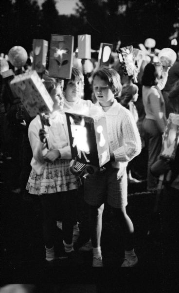 Madison Youngsters Participate in Lantern Parade at Tenney Park Madison's eastside youngsters participating in a lantern parade held at Tenney Park. The lanterns were constructed as part of the city recreation department's summer playground program.