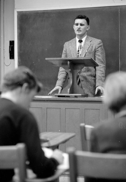 State High School Debate Tournament Student John Wilkinson, Tomah High School, speaking from the podium in the forensics tournament held in Bascom Hall on the University of Wisconsin campus.
