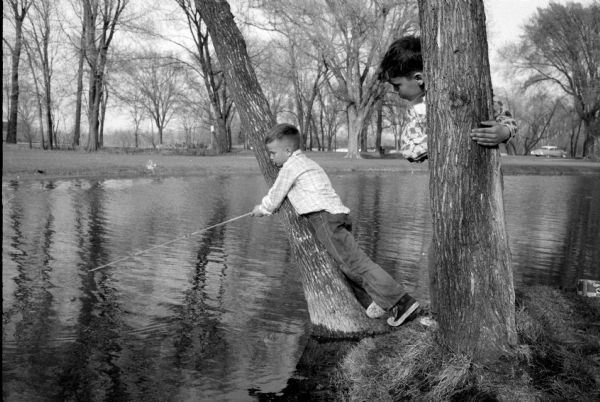 Boys Enjoy a Spring Day at the Fishing Pond Michael Larson of 1417 Fremont Avenue and Daniel O'Neill of 3114 Sherman Avenue try their fishing style amidst the trees at the Tenney Park lagoon.