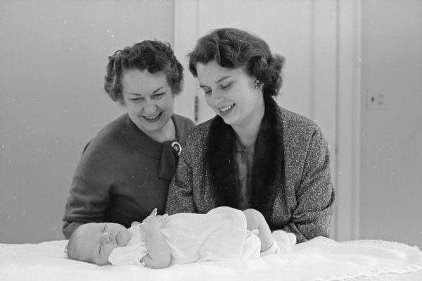 First Grandchild of the University of Wisconsin President Grandmother Mrs. Constance Elvehjem and her daughter Mrs. Peggy Henninger admire the first granddaughter, Laurie Henninger.