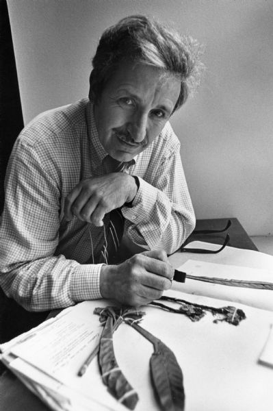 Hugh Iltis Hugh Iltis seated at his desk with botanical specimens.