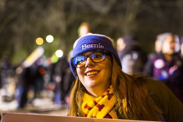 Bernie Sanders Supporter Close-up of a young woman standing outdoors and smiling. She wears a Bernie Sanders knit hat.