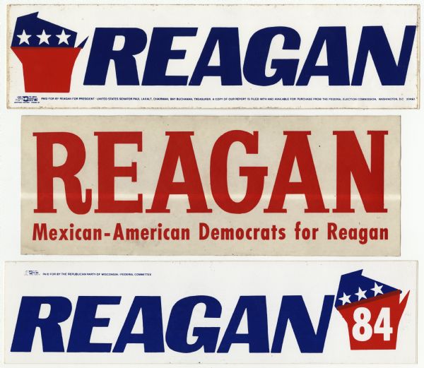 Three presidential political campaign bumper stickers for Ronald Reagan. The top bumper sticker has an image of the shape of the state of Wisconsin, which is split in half horizontally by a change in color, with the top in blue with white stars and the bottom in red. It reads: "Reagan." The middle bumper sticker has red text and reads: "Reagan, "Mexican-American Democrats for Reagan." The bottom bumper sticker is white with blue text that reads: "Reagan," and on the right is an image of the shape of the state of Wisconsin, which is split in half horizontally by a change in color, with the top in blue with white stars and the bottom in red with white text that reads: "84."