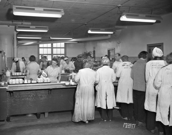 Oscar Mayer Company cafeteria, showing workers standing in a food line.