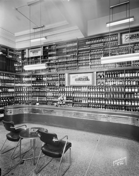 Interior view of the Park Hotel liquor store, 22 South Carroll Street, with tubular metal table and chair sitting in the middle of the room.