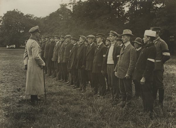Training Recruits Wounded German officer training recruits who are still in civilian clothing.