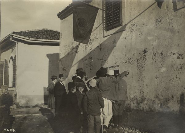 Skutari Street Scenes Proclamation for the Montenegrins, Montenegro and Albania. Residents gathered around a wall placard printed with announcements, issued by the military authorities, in several languages.