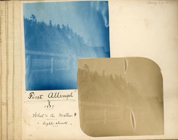 Scrapbook page containing a cyanotype and albumen print of a picket fence and the caption: "First Attempt;" 1887, What's the Matter? "Light struck."