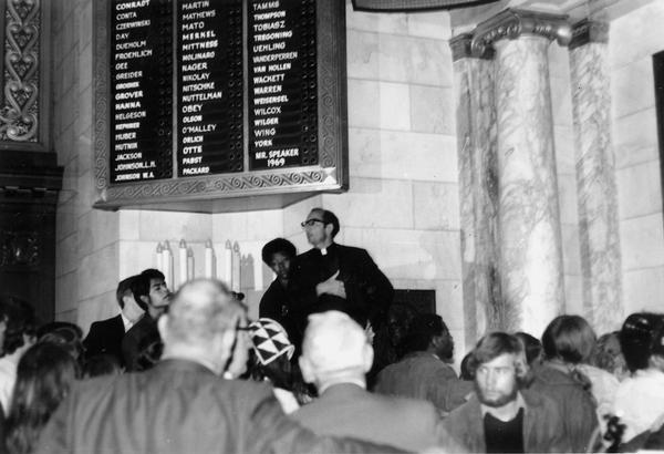 Father Groppi speaking at demonstration in the Wisconsin State Capitol Assembly Chamber.