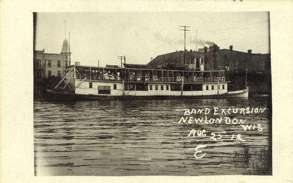 A band excursion on the sternwheel excursion, "Thistle." The sternwheel was previously named "J.H. Crawford."