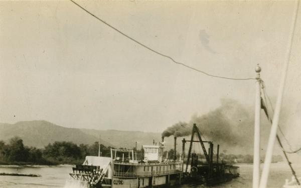 The <i>Clyde</i> after being converted to a sternwheel rafter, pushing a tow with a locomotive on board.