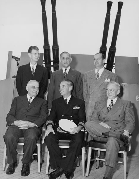 Members of the official Silver Presentation Delegation on board the USS "Wisconsin". Bottom left to right: Judge Rosenberry, Captain Roper, and Oscar Rennebohm Standing left to right: E.N. Doan, William Schwanke, and John Dickinson.