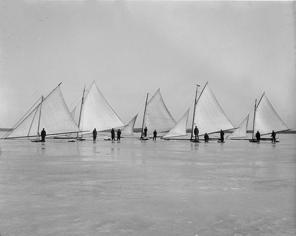 A gathering of iceboats and their captains on Lake Mendota.