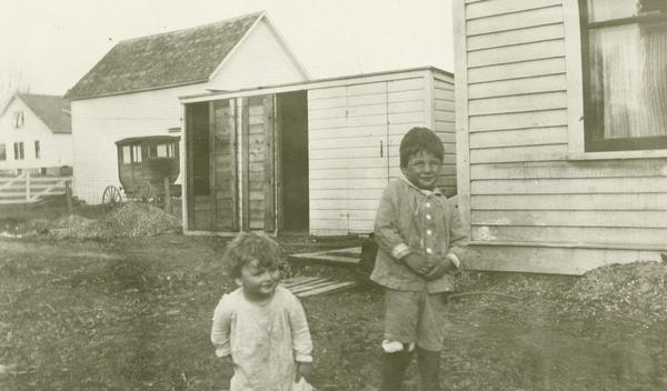 Gaylord Nelson and his brother Stannard play behind the office of their father A. N. Nelson.