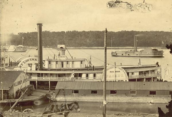 Elevated view of the steamboat <i>Golden Era</i>, which did service during the Civil War, docked near buildings. It was sold to Michael Purcell of New Orleans in 1866 and abandoned in 1868.