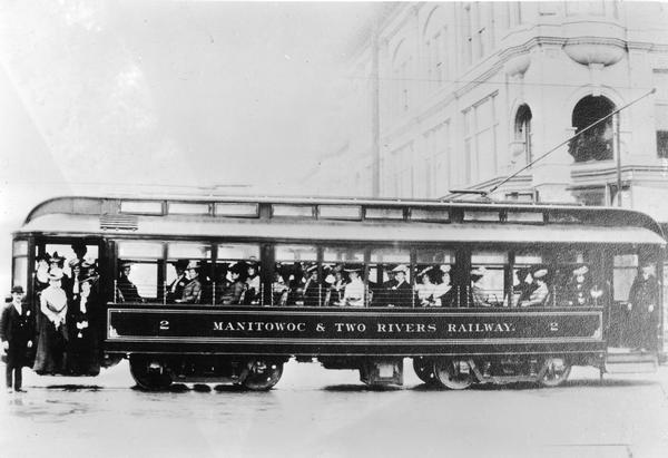 Manitowoc and Two Rivers Railway streetcar full of passengers.