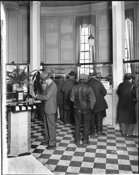 Lobby of the Security State Bank, with depositors waiting in line at teller's windows.