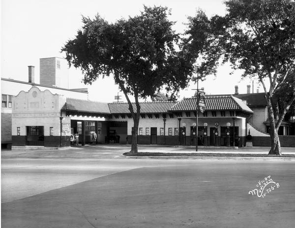Robert Mitchell's Madison service station, 529 University Avenue. During the 1920s service stations evolved from curb-side shacks to more attractive buildings that echoed popular residential architecture. Local wags called Mitchell's large Spanish Revival station, with its five pumps and four bays: "Mitchell's Greasing Palace." 

