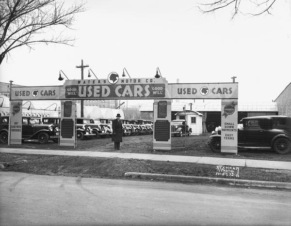 Leon J. Waters standing in front of his used car lot at 746 E. Washington Avenue where he offered small down payments, easy terms, and good will. A small Trachte building seen in the background functioned as his office. At this time East Washington Avenue was known as Madison's "automobile mile."