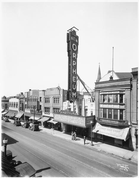 Elevated view of buildings in the 200 block of State Street, with the Orpheum Theatre as a focal point. The theatre marquee reads "New Orpheum." Next door to the theatre on the right is The Family Shoe Store. On the left is Brown & Barels, Speth's Clothes, the Cardinal Pharmacy, and a floral company.