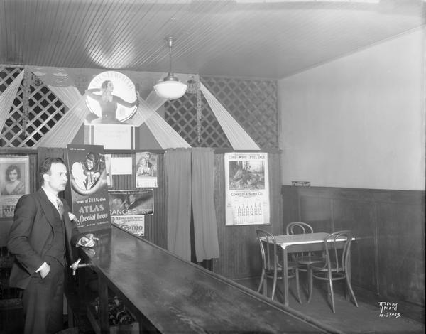 Interior of Joe's Place with bartender, possibly Joseph Puccio. The bar was located at 786 W. Washington Avenue in what was known as the Greenbush neighborhood.
