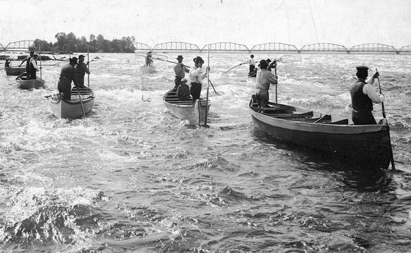 A group of Ojibwa men fishing from boats.