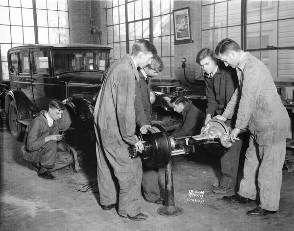 Auto Mechanics Class at East High School. The students left to right are Raymond Cattell, Leif Breiby, Clarence Elsa, Leslie Hoppe, and instructor Orian Dhein.