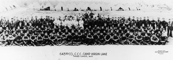 Large group portrait, including six cooks, of people of the 643rd Company, C.C.C. at Camp Virgin Lake.