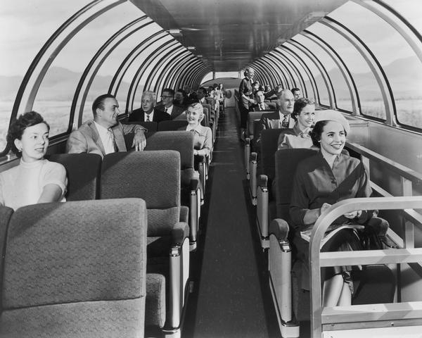 Passengers seated on the upper level of a Milwaukee Railroad superdome coach.