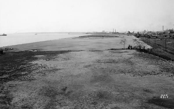 Bare expanse of land with the Milwaukee lakeshore and the city in the distance.