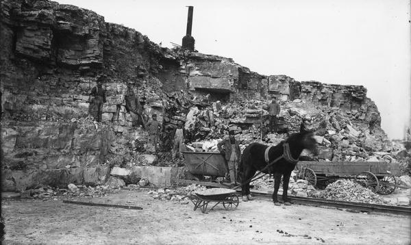 Miners and a mule work outside an iron mine near Mayville.