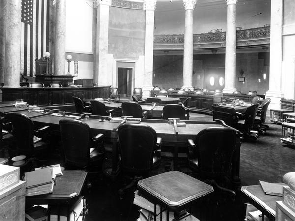 The Senate Chamber of the Wisconsin State Capitol in a quiet moment. Although the senate met in its new chamber in January 1913, much of the marble work on the walls remained unfinished, and the murals of Kenyon Cox were not installed until 1915.