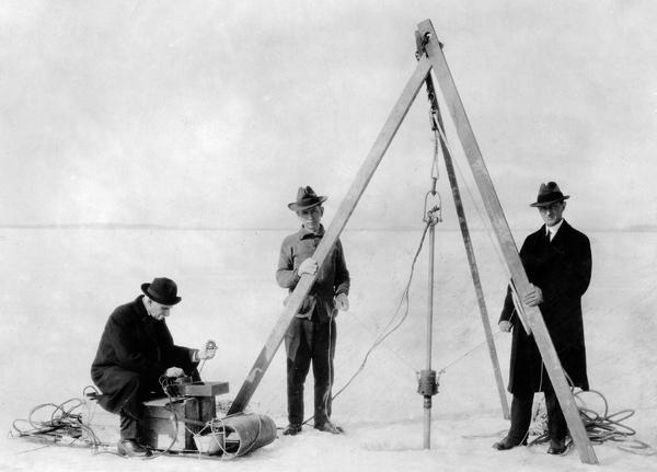 Dr. Edward Birge, March, and Professor Chancey Juday with the first mud thermometer on the ice.