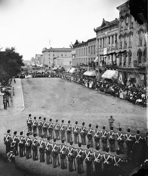 Elevated view from the Park Hotel looking east to the corner of Carroll and Main Streets in Madison. Soldiers are in formation as a part of the centennial celebration.