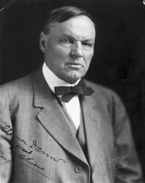 Quarter-length portrait of Clarence Darrow, signed by Darrow and embossed by photographer Mabel Sykes.