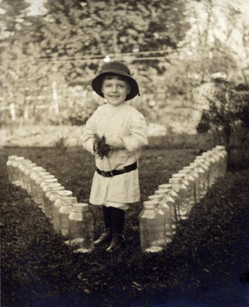 Warren Fenn Bodurtha Gardner, almost 5, poses with empty Horlick's Malted Milk bottles as testament to the benefits of drinking Horlick's. Young Gardner's mother died shortly after he was born, and he couldn't tolerate pure cow's milk. His aunt and grandmothers fed him Horlick's, resulting in the healthy boy pictured here.